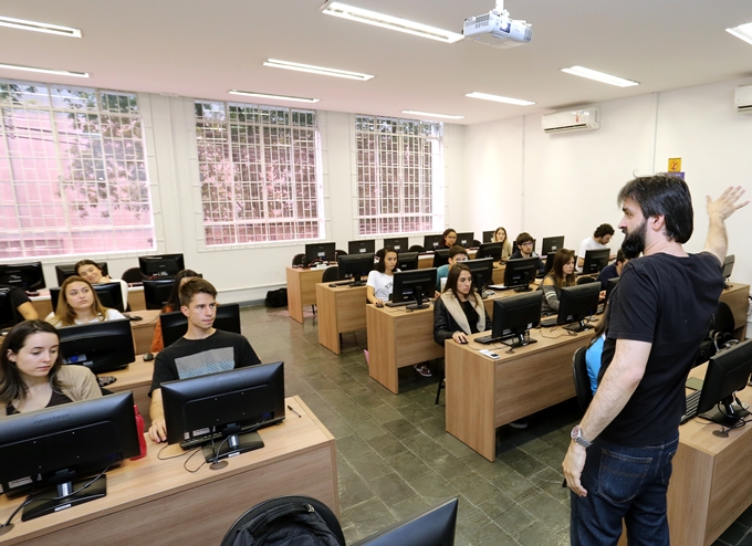 O técnico de controle do TCE-PR André Fadel orienta alunos da Universidade Positivo que atuam na apuração do Índice de Transparência da Administração Pública (ITP). Foto: Wagner Araújo/Divulgação TCE-PR